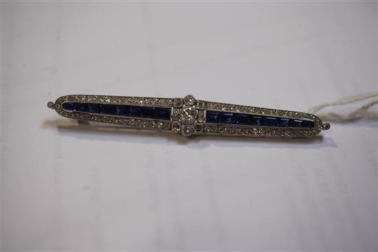 An Art Deco white gold?, sapphire and diamond bar brooch, 7.7cm.